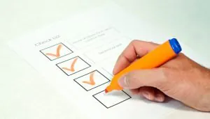 Pessoa anotando qualidades em um pedaço de papel